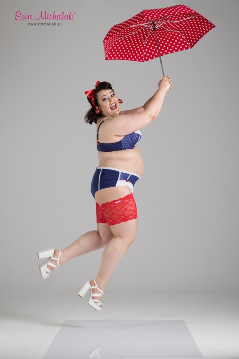 A Ewa Michalak model looking happy as she jumps in the air with an umbrella